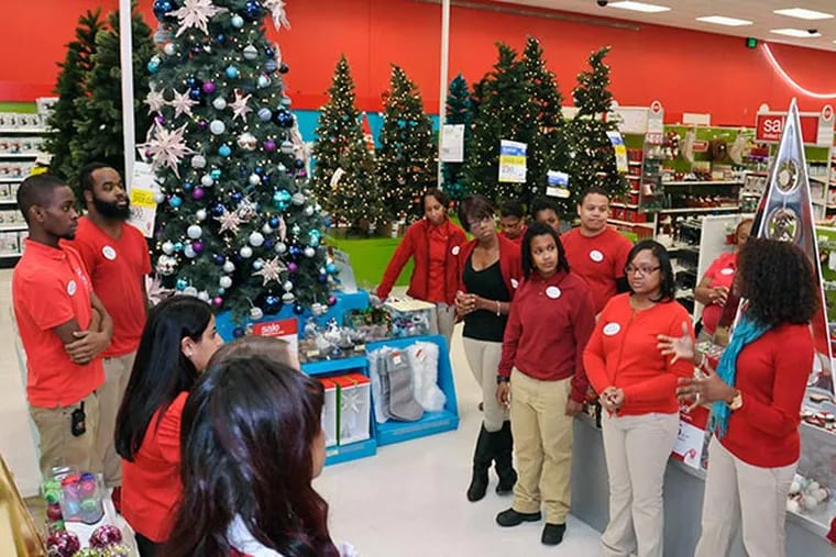 Members of the sales team for the Target store in Wyncote do their daily huddle in the seasonal department before the start of the day. November 21, 2013 ( RON TARVER / Staff Photographer )
