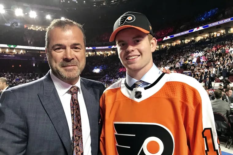 Flyers coach Alain Vigneault and the team's first-round selection, defenseman Cam York, at the 2019 draft.