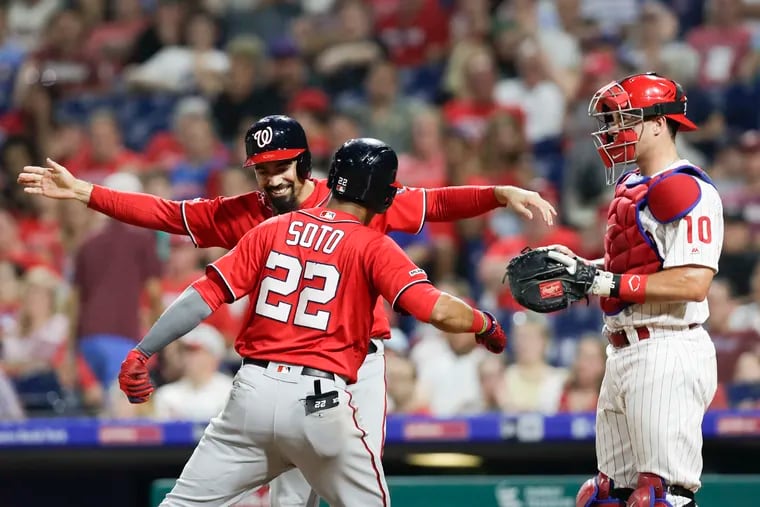 Washington Nationals Juan Soto celebrates his two run ninth-inning home run with teammate Anthony Rendon past Phillies catcher J.T. Realmuto on Saturday, July 13, 2019 in Philadelphia.