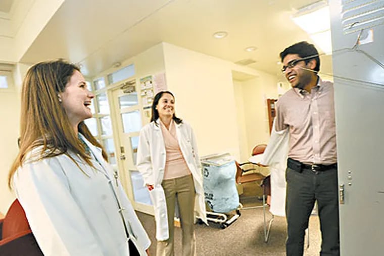 At the Hospital of the Univerity of Pennsylvania in Philadelphia, chief resident Mary Porteous (left); second year resident Tess Bittermann; and second year resident Amar Bansal share a moment in the resident lounge. (April Saul / Staff Photographer)