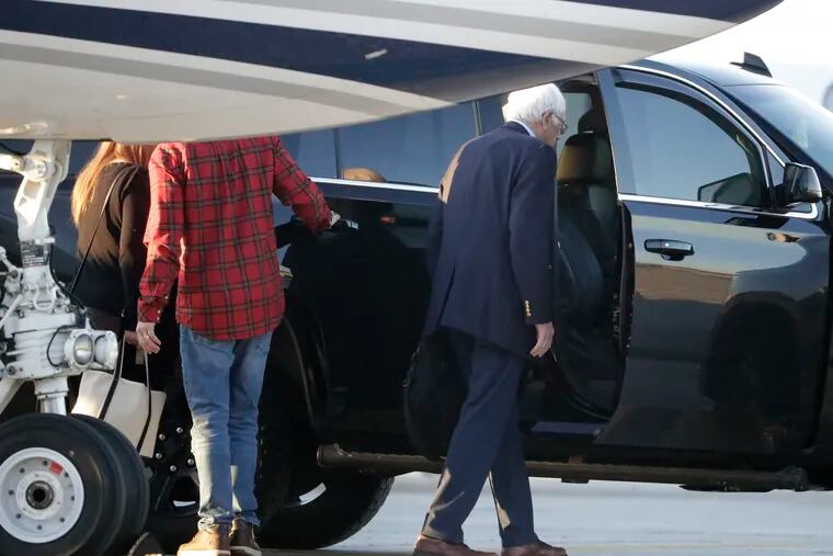 Democratic presidential candidate Sen. Bernie Sanders, I-Vt., right, enters a vehicle after disembarking from a plane at Burlington International Airport in South Burlington, Vt., on Saturday, Oct. 5, 2019.