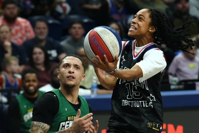 Alexis Morris drives to the basket for a layup as a member of the Harlem Globetrotters.
