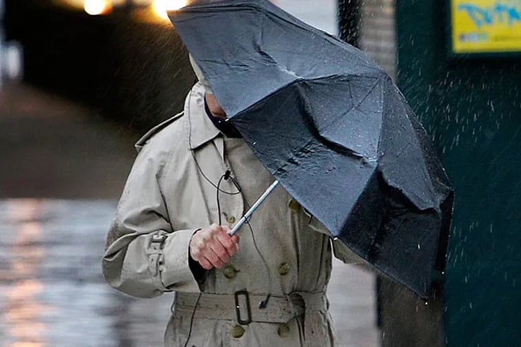 A Center City pedestrian walks underneath his umbrella. Rain is expected midweek.  (Alejandro A. Alvarez, File / Staff Photographer)