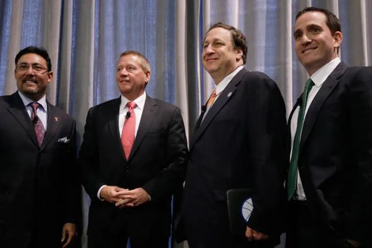 From left, Phils GM Ruben Amaro Jr., Comcast-Spectacor president Peter Luukko, 76ers CEO, Adam Aron, and Eagles GM Howie Roseman, pose for photographers after they took part in a panel discussion on the impact of sports, hosted by the Rothman Institute, Wednesday, May 22, 2013, in Philadelphia. (Matt Rourke/AP)