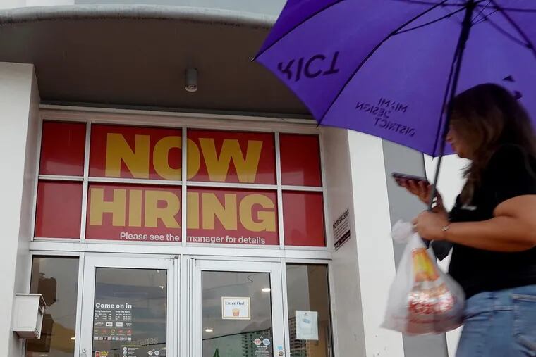 A "Now Hiring" sign hangs above the entrance to a McDonald's restaurant on Nov. 5, 2021, in Miami Beach, Florida. (Joe Raedle/Getty Images/TNS)