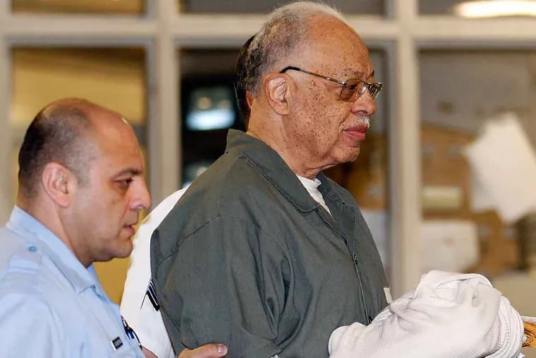 Kermit Gosnell is escorted to a van after getting convicted on three counts of first-degree murder on May 13, 2013.