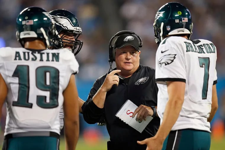 Chip Kelly looks at Sam Bradford during a timeout.