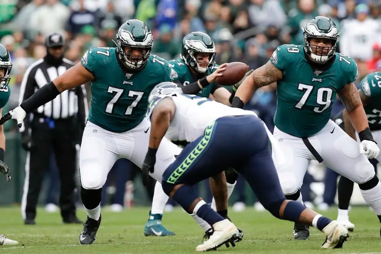 Eagles offensive tackle Andre Dillard (77) and offensive guard Brandon Brooks (79) watch Seahawks defensive tackle Quinton Jefferson in the first-quarter on Sunday.