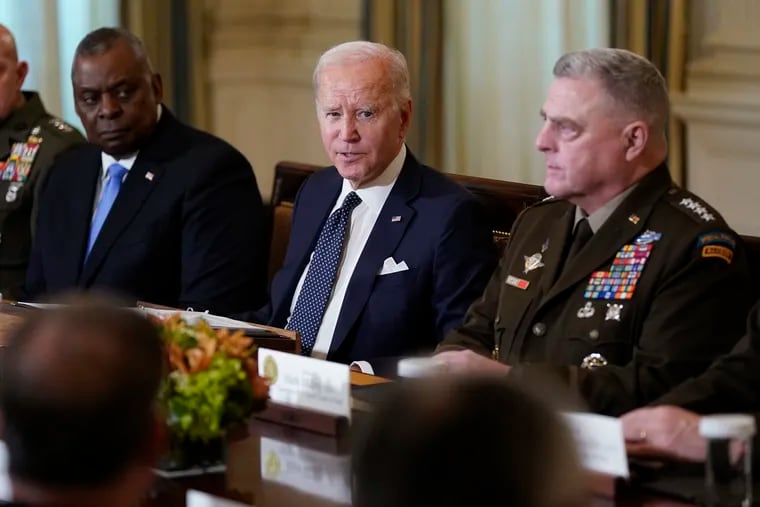 President Joe Biden meets with military leaders, including Defense Secretary Lloyd Austin (left) and Chairman of the Joint Chiefs of Staff Gen. Mark Milley, in the State Dining Room of the White House in Washington last month.