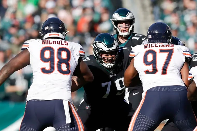 Brandon Brooks keeps both Chicago's Bilal Nichols (left) and Nick Williams away from Carson Wentz in a home victory, Nov. 3, 2019.