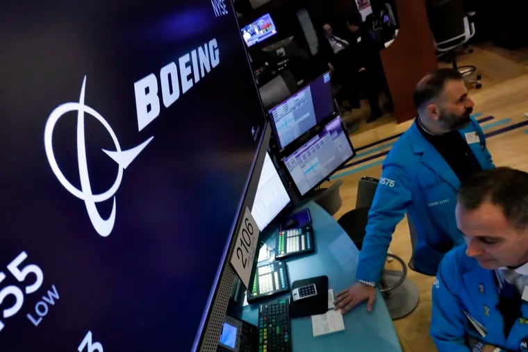 The Boeing logo appears above a trading post on the floor of the New York Stock Exchange.