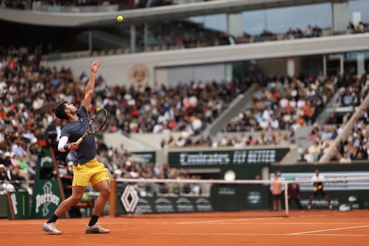 Carlos Alcaraz of Spain serves against Felix Auger-Aliassime of Canada in the Men's Singles fourth round match during Day Eight of the 2024 French Open at Roland Garros on June 02, 2024 in Paris, France. (Photo by Clive Brunskill/Getty Images)