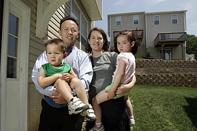 Victor Ko, wife Eileen and their children,  Andrew, 3, and Elisabeth, 4, at their Drexel Hill home.  Victor pays about $7,000 in taxes for his home valued at about $250,000. (Laurence Kesterson / inquirer)