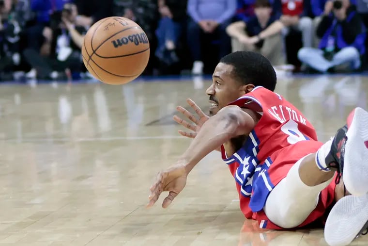 The Sixers' De’Anthony Melton dives, saving the ball from going out of bounds in a game against the Los Angeles Lakers.