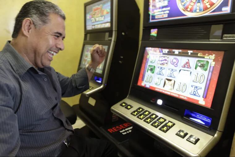 An Illinois restaurant owner tries out a  video poker machine at his business.
