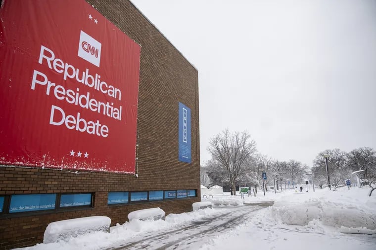 Signs are displayed ahead of Wednesday's Republican presidential debate at Drake University in Des Moines, Iowa.