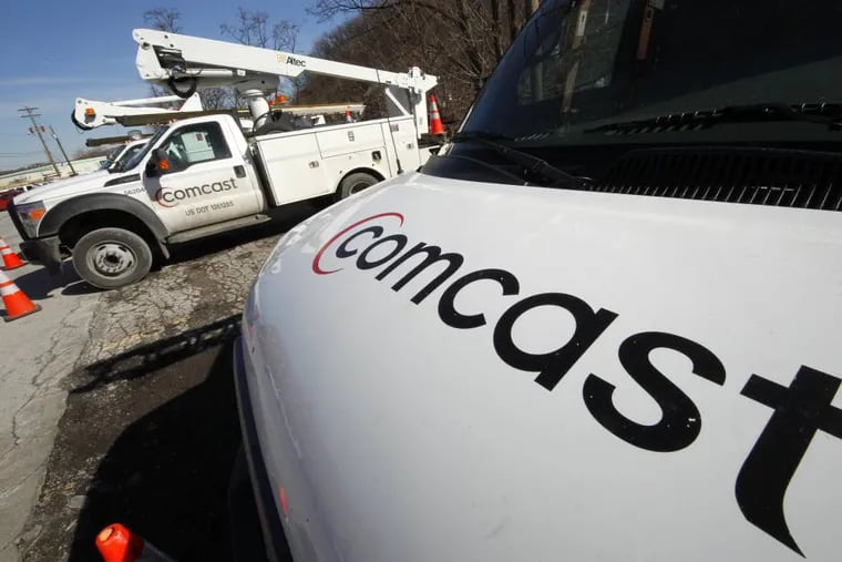 FILE - This Feb. 15, 2011 file photo shows Comcast installation trucks in Pittsburgh. Comcast Corp. reports quarterly financial results before the market opens Tuesday, July 22, 2014. (AP Photo/Gene J. Puskar, File)