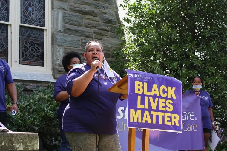 Venus Russell,  a unit support coordinator at Chestnut Hill Hospital, speaks at a rally held on July 20, 2020, during the Strike for Black Lives. Most in Russell's union make under $20 an hour and have not received any hazard pay while working throughout the pandemic.