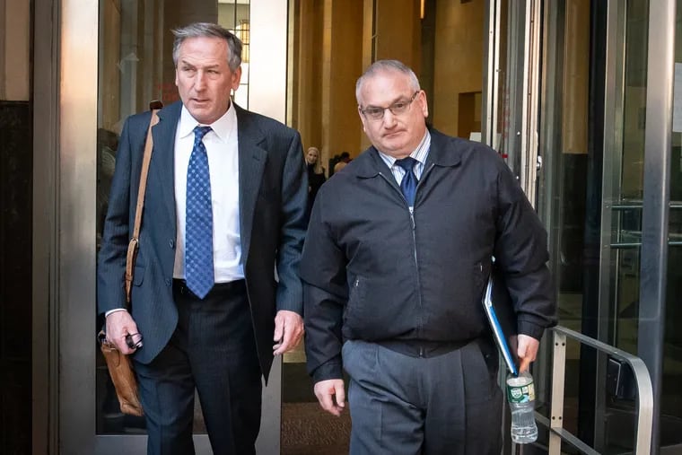 Former Philadelphia homicide detective Philip Nordo, center, is seen exiting the Philadelphia criminal courthouse with his lawyer Michael van der Veen. Nordo was convicted of rape and official oppression.