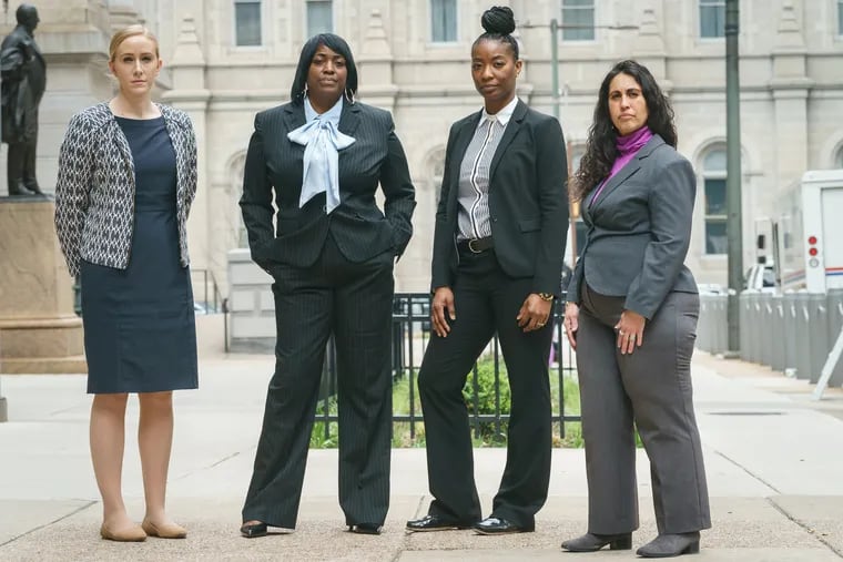 (Left to Right)  Assistant District Attorney Ashley Toczylowski, Keyna Drinks, widow of murder victim Kevin Drinks, Assistant District Attorney Christian Wynne, and Kathy Lees, Victim Witness Coordinator, shown here outside City Hall, in Philadelphia, Tuesday, April 19, 2022. Toczylowski, Wynne and Lees worked with Drinks worked to get justice in the 2011 death of her husband, Kevin.