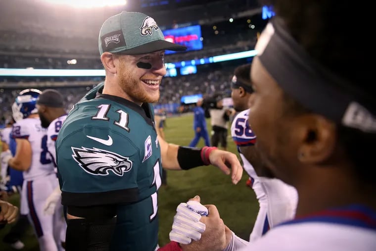 Eagles quarterback Carson Wentz (11) celebrates after a game against the New York Giants at MetLife Stadium in East Rutherford, N.J., on Thursday, Oct. 11, 2018. The Eagles won 34-13.