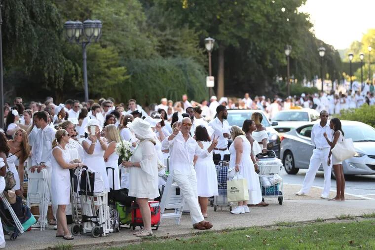 People begin to arrive for Diner en Blanc on the Art Museum steps and surrounding area Thursday August 18, 2016.