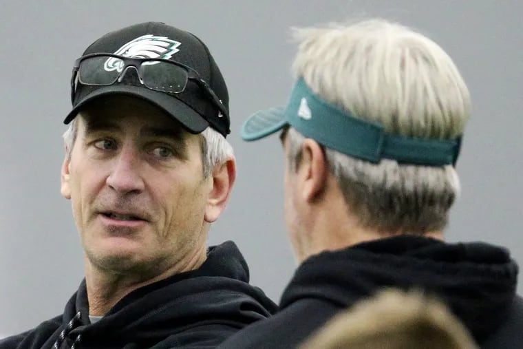 Eagles offensive coordinator Frank Reich, left, talks with head coach Doug Pederson during practice at the NovaCare Complex in South Philadelphia on Thursday, Jan. 18, 2018.