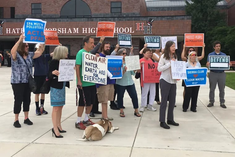 Protesters held signs outside Hatboro Horsham High school, where EPA officials met with local residents and officials to discuss water contamination.