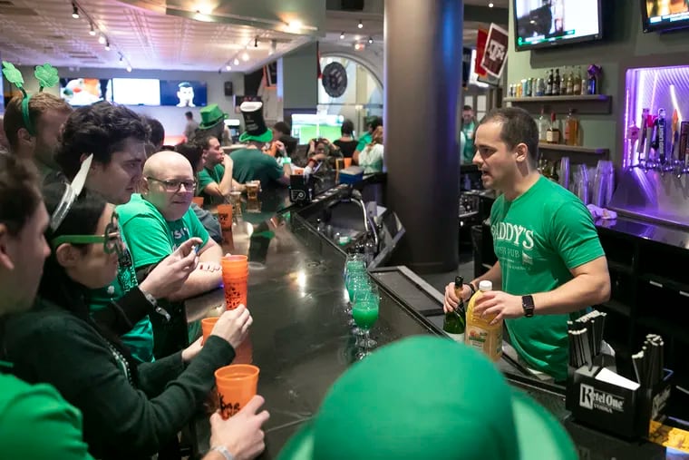 People order drinks and crowd around the Field House bar in Center City Philadelphia on Saturday, March 14, 2020. People were celebrating in honor of St. Patrick's Day at the bar, despite social distancing recommendations due to the rapid spread of the coronavirus.
