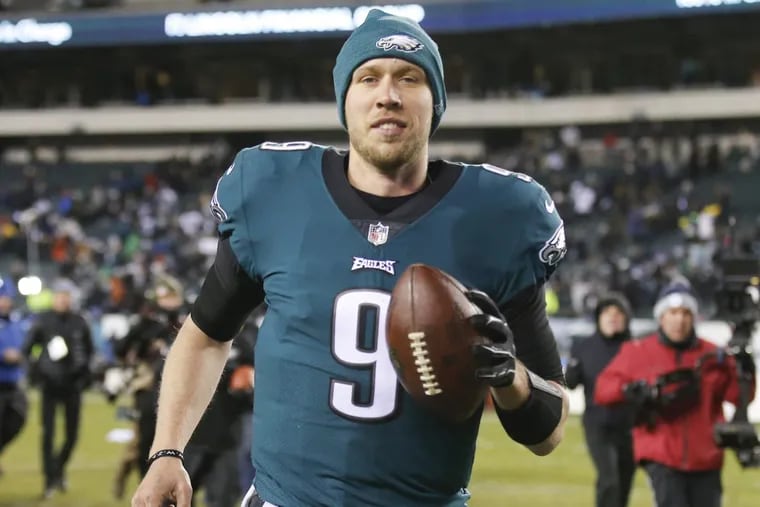 Eagles quarterback Nick Foles smiles running off the field after the Eagles beat the Atlanta Falcons in the playoffs on Saturday.