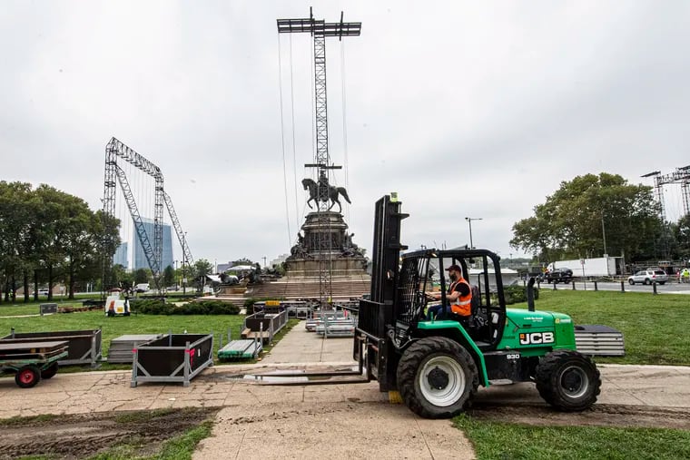 Workers assemble stage lights in preparation for the Made in America concert on the Benjamin Franklin Parkway.