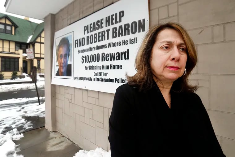 Maria Baron in front of a sign posted on the front of Ghigiarelli's Restaurant in Old Forge ,Lackawanna County. Robert Baron disappeared from there on Jan. 25, 2017.