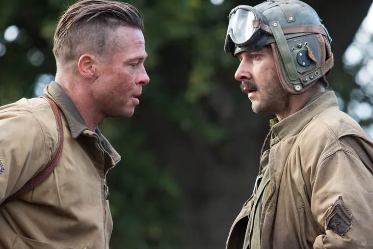 This photo released by Sony Pictures Entertainment shows, Brad Pitt, left, as Wardaddy, and Shia LaBeouf as Boyd "Bible" Swan, in a scene from Columbia Pictures' "Fury." (AP Photo/Sony Pictures Entertainment, Giles Keyte)