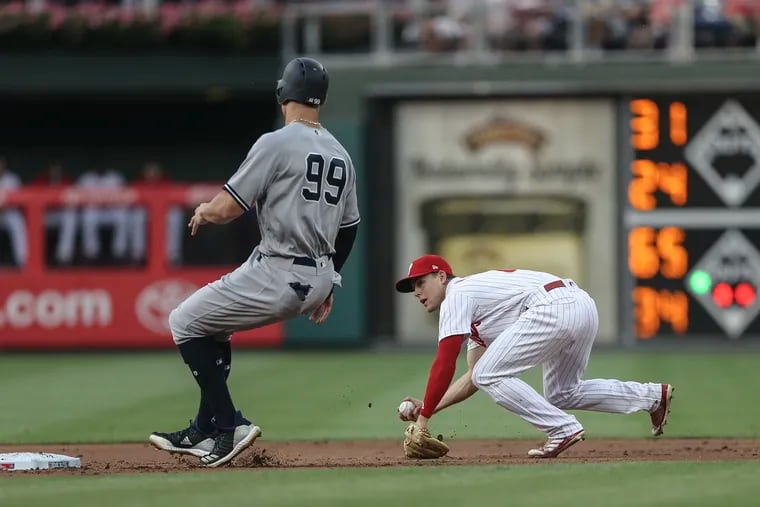 Phillies shortstop Scott Kingery has no play after a bobbled ball during the third inning o the Phillies loss to the Yankees on Tuesday.