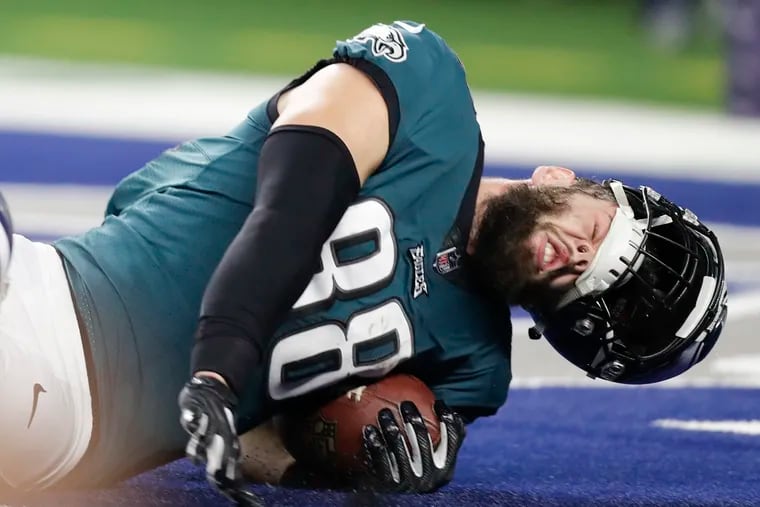 Eagles tight end Dallas Goedert loses his helmet while scoring past Cowboys cornerback Anthony Brown. The TD was called back after Goedert was called for offensive pass interference on the play.
