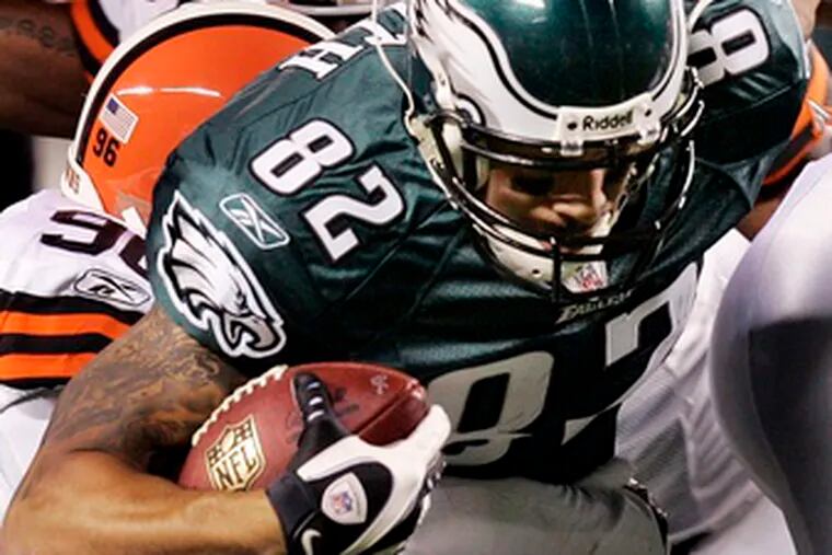 Tight end L.J. Smith is brought down by the Browns&#0039; Alex Hall (96) and Andra Davis. Smith has improved his play in the Eagles&#0039; last three wins.