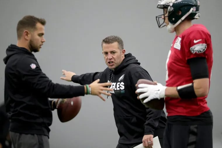 Eagles’ quarterbacks coach John DeFilippo, center, works with Nick Foles, right, as the Philadelphia Eagles practice during the bye week in Philadelphia, PA on January 3, 2018. The Eagles will host a playoff game on Saturday, January 13.
