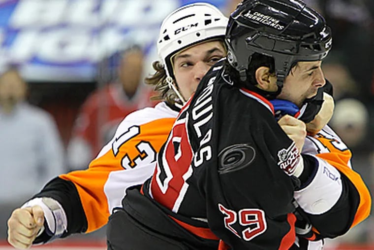 Carolina Hurricanes' Tom Kostopoulos and Flyers' Dan Carcillo fight during the second period.   (AP Photo/Gerry Broome)