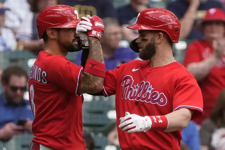 The  Phillies' Bryce Harper is congratulated by Nick Castellanos (left) after hitting a home run during the seventh inning against the Milwaukee Brewers.