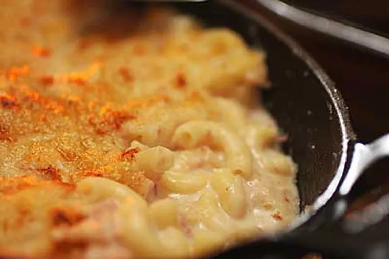 At 10 Arts, chef de cuisine Jennifer Carroll, inspired by her mother's recipe, creates a creamy mac and cheese studded with ham and covered with a Gruyère crust and sourdough bread crumbs. (MICHAEL BRYANT / Staff Photographer)
