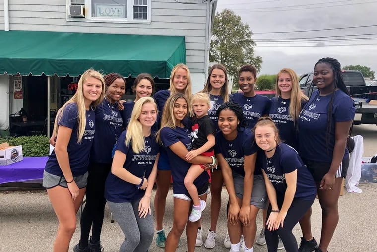 The Thomas Jefferson University Women's Basketball team with young Bella Borkowski, center, at the Beats for Bella charity golf outing.
