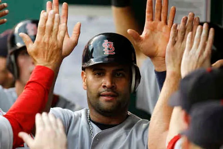 The Cardinals' Albert Pujols has moved into first place in the fans' National League all-star voting, past Chase Utley.