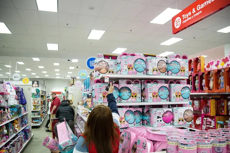 An employee arranges toys on a rack at a Target Corp. store in Westbury, N.Y.