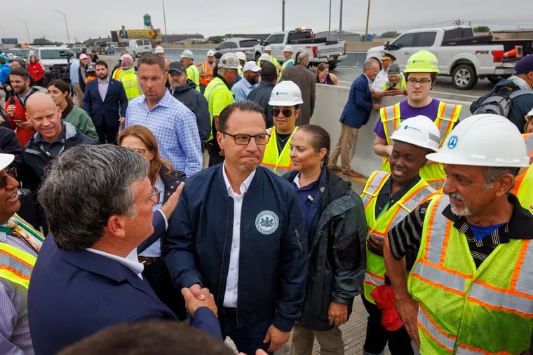 Gov. Josh Shapiro shakes hands with Mike Carroll, Pennsylvania secretary of transportation at the site of the I-95 bridge collapse earlier this month.