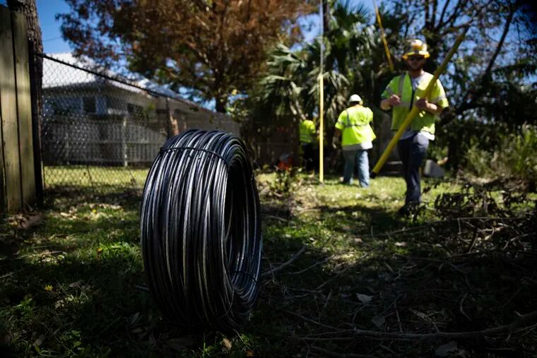 Workers for Florida Power and Electric repair a power line damaged by Hurricane Ian in Naples, Fla., on Monday. The utility said Monday that it expects to have nearly all power restored to its customers with habitable homes by the end of the week.