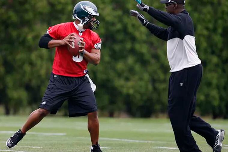 Harold Carmichael, right, rushes Donovan McNabb, left, during Eagles practice at the NovaCare Complex in South Philadelphia on June 3, 2009.
