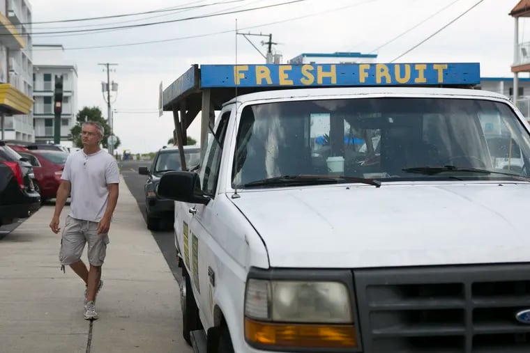 Bill Baxavaneos, an employee at Island Produce Market, stops the well-known fruit truck at a hotel in Wildwood, N.J., on the morning of Thursday, July 12, 2018, to sell to vacationers. MAGGIE LOESCH / Staff Photographer