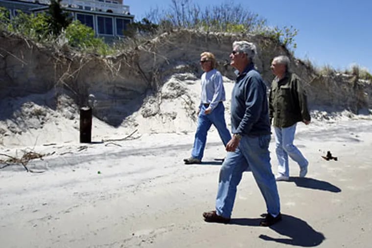 Strathmere residents (from left) Randy Roash, Dick Omrod and Ted Kingston walk along the eroded beach at Corson's Inlet State Park. (David Maialetti / Staff Photographer)