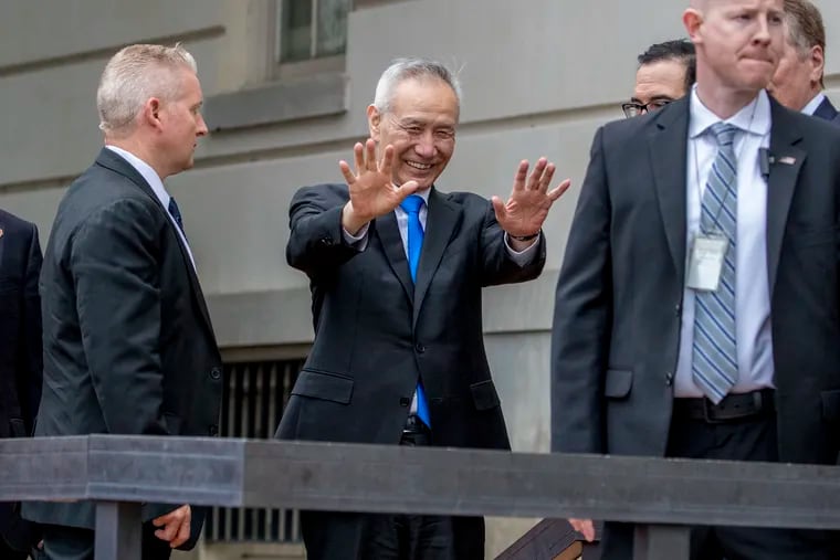 Chinese Vice Premier Liu He, center, waves to members of the media as he arrives at the Office of the United States Trade Representative in Washington, Friday, May 10, 2019 for trade talks between the United States and China.
