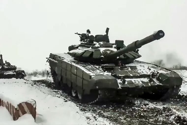 In this photo taken from video provided by the Russian Defense Ministry Press Service on Wednesday, a Russian tank roll during a military exercising at a training ground in the Rostov region of Russia.